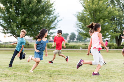 kids running in grass field