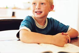 child drawing in workbook