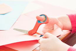 cutting paper with paper scissors